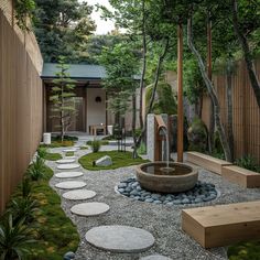 an outdoor garden with stepping stones and a water feature