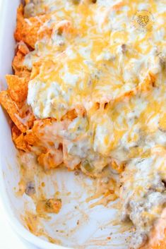 a casserole dish with cheese, meat and tortilla chips in it