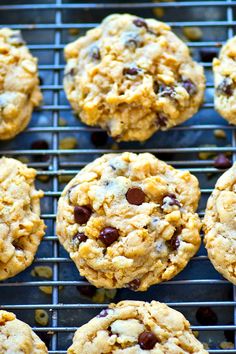 chocolate chip cookies cooling on a wire rack with oats and raisins in the middle