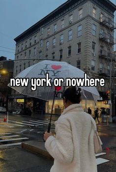 a person walking down the street with an umbrella in front of them that says take me to nyc