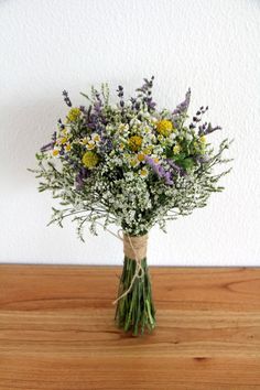 a bouquet of wildflowers in a vase on a table