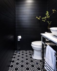 a white toilet sitting next to a sink in a bathroom