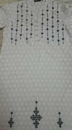 a white shirt with black crosses on it