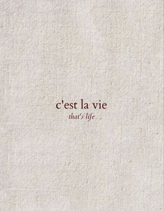 the words are written in red on a white linen background with an inscription that reads cest la vie, that's life