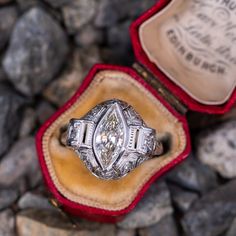 Circa 1930s ring features a pierced design and bordered with milgrain edging. Engraved details accent the shank. The ring is centered with one (1), bezel set, marquise brilliant cut diamond weighing 1.57 carats. The ring is accented with four (4), bead set, round brilliant cut diamonds, two (2), bead set, round single cut diamonds and six (6), bead set, rose cut diamonds. The ring measures 16.6mm at the top, rises 6.3mm above the finger, tapering to 1.5mm wide and 1.2mm thick at the base of the Gia Certified Marquise Platinum Rings, Gia Certified Platinum Marquise Rings, Gia Certified 14k White Gold Art Deco Ring, Classic Gia Certified Diamond Ring As Collectible, Gia Certified Art Deco Platinum Rings, Gia Certified Platinum Art Deco Ring, Vintage Silver Gia Certified Diamond Ring, Vintage Silver Gia-certified Diamond Ring, Classic Collectible Diamond Ring With Center Stone