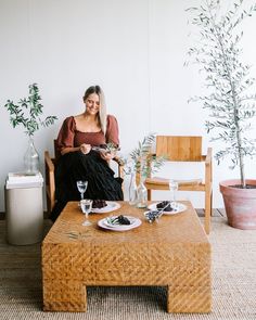 a woman sitting on a chair holding a plate