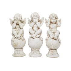 three white angel figurines sitting on top of each other in front of a white background