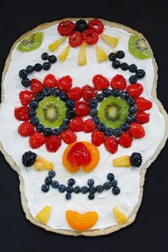 a decorated sugar skull cookie with fruit on it