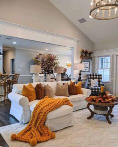 a living room filled with furniture and a chandelier