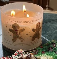 a candle that is sitting next to some cookies