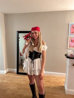 a woman dressed up as a pirate posing for the camera