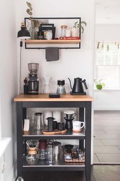 a coffee bar with shelves and cups on it