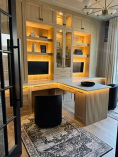 an office with built in desks and cabinets is lit up by recessed lighting