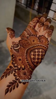 the hand is decorated with henna designs