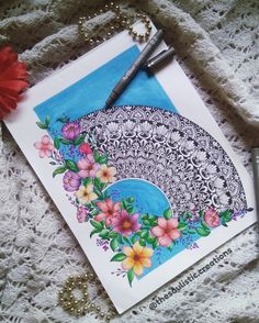 a drawing with flowers on it next to a pen