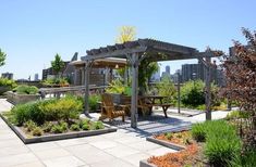 an outdoor garden with wooden benches and tables