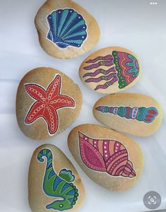 six painted rocks with sea animals on them