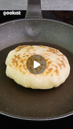 a pancake is cooking in a frying pan on the stove with a video