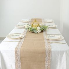 the table is set with plates and place settings