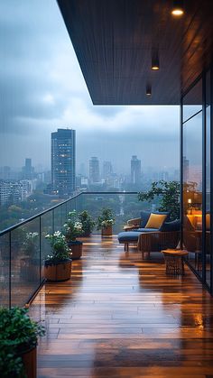 an outdoor deck with chairs and potted plants on it, overlooking the city skyline