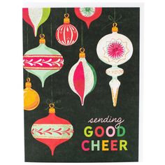 a black greeting card with christmas ornaments hanging from it's sides and the words sending good cheer