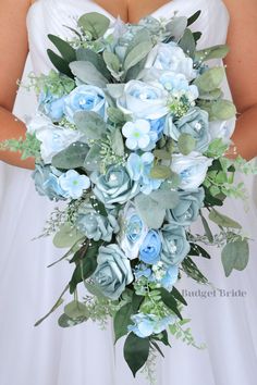 a bridal holding a bouquet of blue flowers