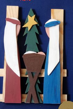 a wooden nativity scene with three wise men and a star on the manger