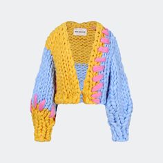 a knitted sweater with pink, blue and yellow details on the shoulders is shown