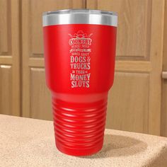 a red tumbler cup sitting on top of a counter