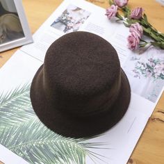 The EMES SHOP hat is detailed with a luxe soft wool material. Features a solid color and bucket hat design.MATERIAL:100% BrushedWool BlendCIRCUMFERENCE MEASUREMENTS: 56-58cm 22-23in Winter Solid Top Hat With Flat Brim, Solid Flat Brim Felt Hat For Winter, Winter Cloche Hat With Flat Brim, Winter Top Hat With Short Brim, Classic Winter Felt Bucket Hat, Classic Felt Bucket Hat For Winter, Wool Felt Hat For Winter, Solid Wool Felt Hat For Winter, Wool Winter Bucket Hat