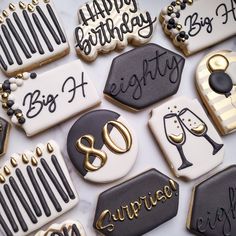 decorated cookies with black and white icing on a table