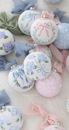 an assortment of decorated easter eggs with bows and bows around them on a white surface