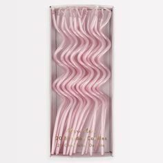 pink plastic straws in a box on a white background