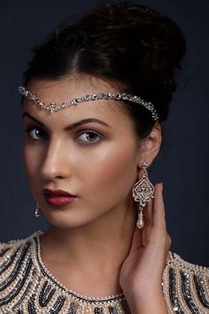 a woman wearing an elaborate head piece and jewelry