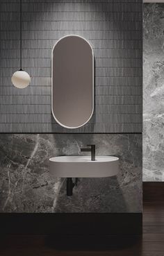 a bathroom with a sink, mirror and lights on the wall next to each other