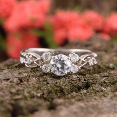 a diamond ring sitting on top of a rock