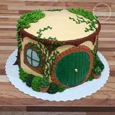 a cake that looks like a hobbot house with trees and grass on it