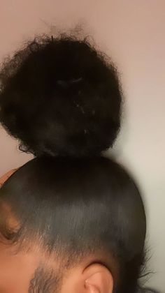 the back of a man's head with an afro on top of his head