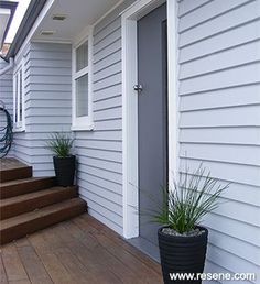 a house with white siding and wood floors