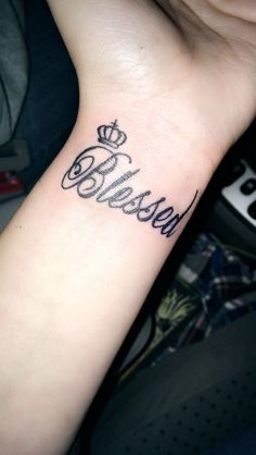 a small wrist tattoo with the word believe on it