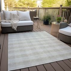 a white rug sitting on top of a wooden deck