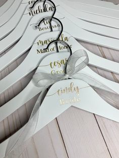 wedding hangers with names and ribbons on them