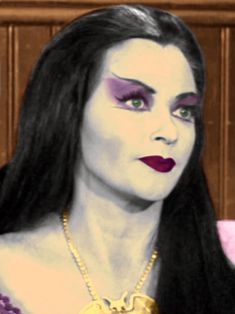 a woman with long black hair and purple makeup