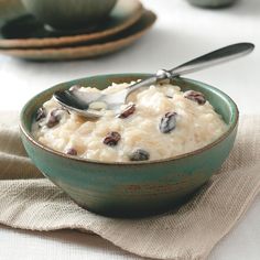 a bowl filled with rice and raisins on top of a table