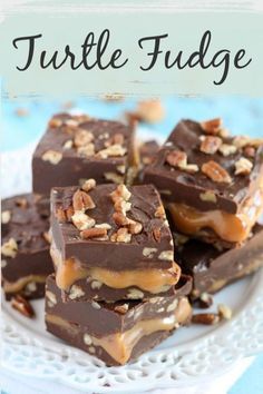 chocolate fudge bars stacked on top of each other with pecans in the middle