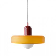 a yellow and red light hanging from a ceiling fixture with a black cord attached to it