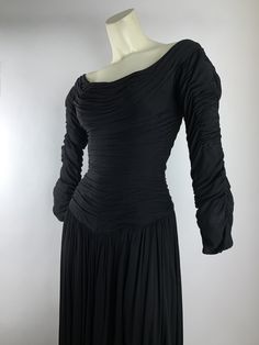 1950's black cocktail dress wrapped in black silk jersey that is gathered & draped around the body perfectly... that only the famous designer Ceil Chapman could create. This is a signature look for this designer. This awesome number has a fitted bodice with a nipped waist, and the silk jersey hugs the body in all the right places.. a classic wiggle dress from the 1950's that has been elevated by the talent of Ceil Chapman. She was the # 1 go to for the Hollywood Stars of the 1950'S.. in fact Ceil Chapman, Dress Drape, Famous Designer, 1940s Dresses, Full Circle Skirts, 50s Dresses, Famous Designers, Black Cocktail, Wiggle Dress