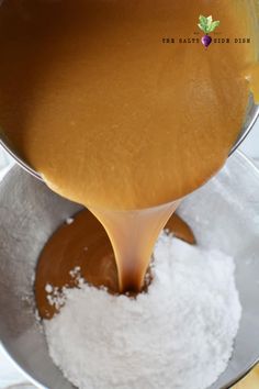 a ladle pours sugar into a bowl filled with powdered sugar and caramel