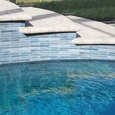 an empty swimming pool with blue water