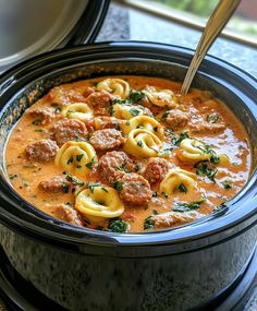 a crock pot filled with pasta and meat